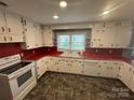 Functional kitchen with white cabinets, red countertops, and ample counter space for cooking at 603 E Main St, Rock Hill, SC 29730