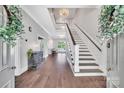 Bright foyer with hardwood floors, chandelier, and staircase leading to the second floor at 8150 Malibu Pointe Ln, Denver, NC 28037