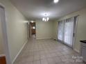 Open dining area with tile flooring and sliding glass door at 837 Corwin Dr, Charlotte, NC 28213