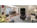 Spacious living room featuring plush carpeting and ample natural light from large windows at 8509 Anette Ave, Mint Hill, NC 28227