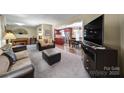 Open concept living room showcases hardwood floors and seamless flow into the dining area at 8509 Anette Ave, Mint Hill, NC 28227