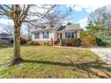 Well maintained home on a grassy lot featuring mature trees, an inviting entrance, and a concrete driveway at 9624 Buckskin Ln, Mint Hill, NC 28227
