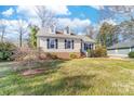 Inviting one-story home with manicured lawn, mature trees, and charming front entrance at 9624 Buckskin Ln, Mint Hill, NC 28227