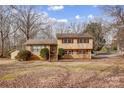 Charming two-story home with a brick and vinyl facade, complemented by well-maintained landscaping at 1142 Canterbury Dr, Lancaster, SC 29720