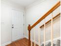 Bright entryway featuring wood-look flooring and a staircase with wooden railing at 1310 Green Oaks Ln # H, Charlotte, NC 28205