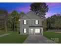 Charming two-story home with neutral siding, black shutters, and a well-manicured front lawn at 1615 Carlton Ave, Kannapolis, NC 28083