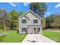 Beautiful two-story home with green grass, a well-kept lawn, and black shutters at 1615 Carlton Ave, Kannapolis, NC 28083