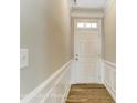 Inviting hallway with white wainscoting and wood-look flooring that leads to the front door with sidelight at 1770 Wardwell Dr # 338, Sherrills Ford, NC 28673