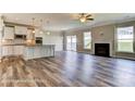 Open-concept living space with fireplace and slider door access to a kitchen with pendant lighting at 1770 Wardwell Dr # 338, Sherrills Ford, NC 28673