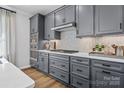 A modern kitchen features stainless steel appliances, gray cabinets and white countertops at 2133 Moss Bluff Dr, Mint Hill, NC 28227