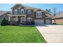 Charming brick home with three-car garage, covered front porch, and well-maintained landscaping at 224 Alexandria Dr, Mooresville, NC 28115