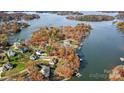 Stunning aerial view of lakefront homes surrounded by vibrant autumn foliage and serene blue waters at 226 Hermance Ln, Mooresville, NC 28117