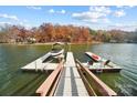 Private boat dock and lake with a boat and kayaks, perfect for waterfront living and enjoying water activities at 226 Hermance Ln, Mooresville, NC 28117