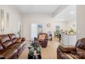 Inviting living room with plush leather seating and a seamless flow to the dining area at 3222 Maple Ridge Dr, Gastonia, NC 28052