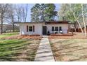 Beautifully landscaped home with a well-maintained lawn and charming front porch, enhancing curb appeal at 324 East End S Ave, Statesville, NC 28677