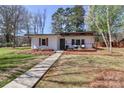 Charming home with modern design, landscaped front yard, and inviting walkway creating curb appeal at 324 East End S Ave, Statesville, NC 28677