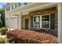 Inviting front porch with brick accents and seating area, perfect for relaxing and enjoying the neighborhood view at 352 Nantucket Way, Rock Hill, SC 29732