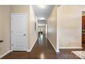 Long hallway with hardwood floors and neutral walls leads to various rooms, creating a seamless transition throughout the home at 352 Nantucket Way, Rock Hill, SC 29732