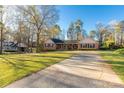 Beautiful brick home featuring a long driveway, mature trees and well maintained lawn at 363 Arrowood Ave, Lancaster, SC 29720