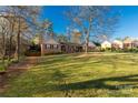 Charming brick home featuring a well maintained front yard with mature trees at 363 Arrowood Ave, Lancaster, SC 29720