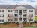 Inviting condo with private balconies, landscaped grounds, and a charming walkway to the entrance at 3960 Town Center Rd, Harrisburg, NC 28075