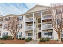 Attractive condo building featuring multiple stories, private balconies, and well-maintained landscaping at 3960 Town Center Rd, Harrisburg, NC 28075