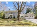 Inviting home with gray shingles, a well-manicured lawn, and a three-car garage at 4501 Mullens Ford Rd, Charlotte, NC 28226