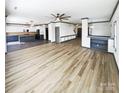Expansive living room with hardwood floors, open concept design, and modern ceiling fan at 5006 Brodie Ln, Fort Mill, SC 29707
