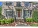 Welcoming front door with white columns, dark shutters, and steps leading to a landscaped yard at 6008 Nuthatch Ct, Charlotte, NC 28277