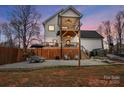 Expansive backyard featuring a multi-level deck, patio area, fenced yard, and outdoor living space at 693 Luther Dr, Iron Station, NC 28080