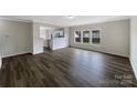 Spacious living room with hardwood floors and a view of the backyard through large windows at 722 Ladino Ln, Clover, SC 29710
