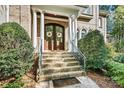 Elegant front entrance with brick steps, white columns, and a charming double-door entry at 7509 Webbs Chapel Cove Ct, Denver, NC 28037