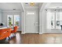 Bright entryway with hardwood floors, a modern chandelier, and large windows letting in natural light at 7807 Chaddsley Dr, Huntersville, NC 28078