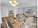 Bright living room and dining area with a modern chandelier and views of the front yard at 9037 Pembroke Ct, Fort Mill, SC 29707