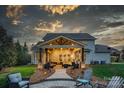 Inviting covered patio with comfortable seating and a stone paver walkway for outdoor entertaining at 1005 Palace Ct # 58, Indian Trail, NC 28079