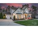 Beautiful two-story home with an attached garage and well-maintained lawn and appealing stone accents at 1005 Palace Ct # 58, Indian Trail, NC 28079