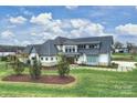 A lakefront home featuring a modern farmhouse design and well-maintained landscaping at 101 S Shore Dr, Belmont, NC 28012
