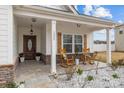 Charming covered front porch with rocking chairs, stone accents, and craftsman-style details at 1205 Brooksland Pl, Waxhaw, NC 28173