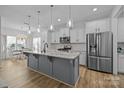 Bright kitchen featuring granite countertops, white cabinets, stainless steel appliances, and an island at 1205 Brooksland Pl, Waxhaw, NC 28173