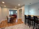 Open-concept dining and kitchen area with hardwood floors and a view into a cozy living room at 1239 Mitchell Ave, Statesville, NC 28677
