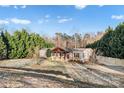 Inviting single-story home featuring a charming covered porch, lovely landscaping, and a serene, tree-lined setting at 126 Goat Trl, China Grove, NC 28023