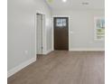 Bright living room with light gray walls, wood-look floors, and a view of the front door at 132 Shady Grove Rd, Kings Mountain, NC 28086