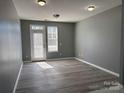 Bright, open living room featuring gray walls and modern laminate flooring at 1634 Walnut View Dr, Charlotte, NC 28208