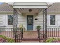 Inviting front porch with decorative iron railings and a cozy seating area at 1644 Morningside Dr, Charlotte, NC 28205