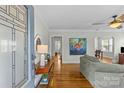 Inviting living room features hardwood floors, a neutral color scheme, and a large stained-glass window at 1644 Morningside Dr, Charlotte, NC 28205