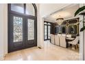 Elegant dining room featuring a modern chandelier, wood floors and a stunning accent wall at 16744 Ashton Oaks Dr, Charlotte, NC 28278