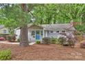 Charming home with a blue door, well-maintained landscaping, and a cozy front porch at 1837 Academy St, Charlotte, NC 28205