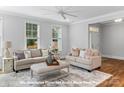 Bright and airy living room with neutral tones, featuring a comfortable seating area and natural light at 19728-B School St, Cornelius, NC 28031