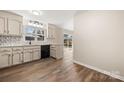 Bright kitchen with modern appliances, custom backsplash, and a view of the backyard through sliding glass doors at 205 King David Ln, Gastonia, NC 28056