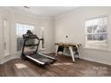 Bright bonus room with hardwood floors, featuring an air hockey table and treadmill at 2426 Tory Oak Pl, Matthews, NC 28105